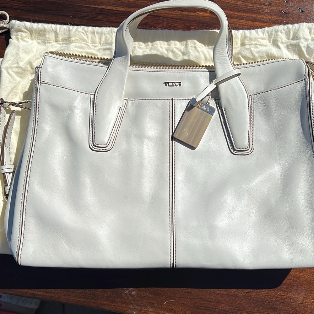 Beautiful Tumi briefcase with laptop padded case and storage bag.